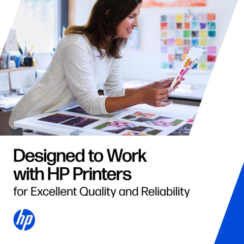 Image of a woman reviewing printed photos on a desk designed to work with HP printers for excellent quality and reliability.