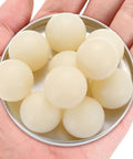 10 Pack Solid Nylon Bearing Balls 1 Inch 25.4 Millimeters Diameter PA6 Precision Plastic Spheres in a hand holding a tin.