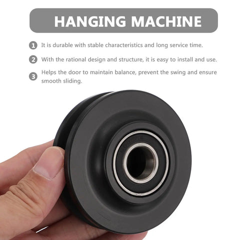 Heavy Duty Nylon Sliding Door Pulley Wheel Roller Featuring Zero Sweat Setup And Smooth Silent Glide For Big Time Home Upgrades And Reliable Heavy Load Support in hand, showcasing black nylon material and bearing.