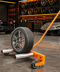 Heavy Duty Adjustable Tire Wheel Dolly With No Sweat Lever Lift Design And 440 Lbs Capacity For Effortless Hub Assembly Moving In Your Workshop And Sturdy Frame with wheel in a garage.