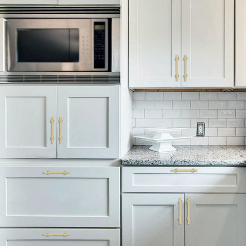 10 Pack 5 Inch Brushed Gold Cabinet Handles Premium Aluminum Zinc Alloy Hella Sleek Hardware Smooth Glide Action For Kitchen Cupboards Closets And Drawers installed on modern white kitchen cabinets.