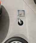 Heavy Duty 4 Inch Spring Loaded Gate Caster Wheel Conquers Rocky Concrete Smooth As Butter Appliance Slider With Beefy Clamp And Self Leveling Suspension Made For Heavy Lifting mounted on concrete.
