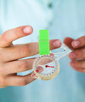 Person holding Directional Thumb Orienteering Compass Handheld Outdoor Navigation Tool For Hiking And Camping With Fast Needle Reset