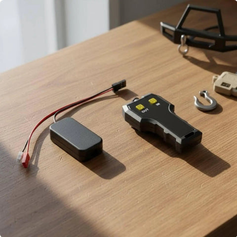 Powerful Electric Winch With Smart Rc Controller For Trail Crawlers featuring a black RC controller and wiring on a wood surface.