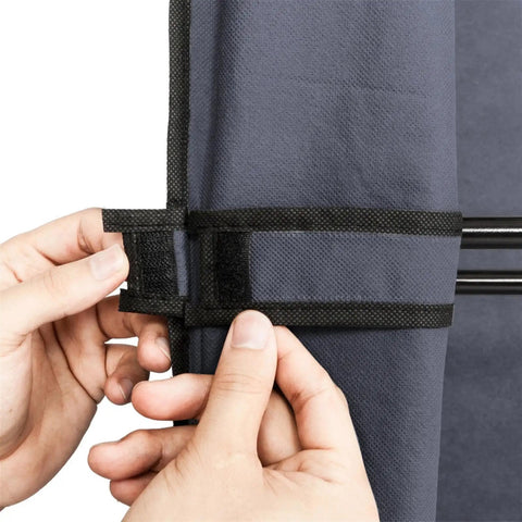 Portable Closet Wardrobe Organizer With Dustproof Cover Freestanding Storage Rack Hella Spacious Clothes Armoire For Dorm Or Apartment Straight Up Easy Pop Up Build Grey showing hands fastening zipper cover detail.