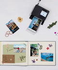 Selphy CP1500 Photo Printer Bundle Wireless Dye Sub Kit with 108 Sheets KP-108 Paper, Three Ink Cartridges, and Tudak Cleaning Cloth shown with a printed photo and scrapbook.
