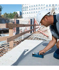Heavy Duty Handheld Wall Scanner And Stud Detector Real Workhorse Multi Function Finder in use by a worker at a construction site.