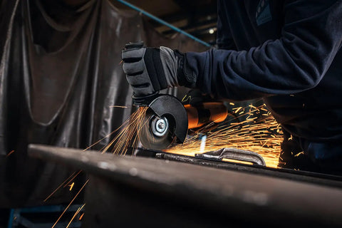 Top Shelf 1400 Watt Angle Grinder Packs Knock Tough 125mm Cutting Muscle, Tilting Gear Head, And Lock Off Shield in action cutting metal.