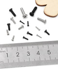 Built Tough Black Carbon Steel Phillips Pan Head Machine Screws 1200 Piece Heavy Duty Tiny Bolt assortment with ruler for size reference.