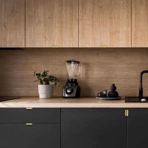 Modern kitchen featuring Premium Gold Cabinet Handles Finger Edge Pulls on black cabinetry and a blender on wooden countertop.