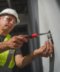 Person using SoftFinish 11inOne Multi Driver Tool With 8 Edged Soft Grip for Max Torque on wall socket during repair.