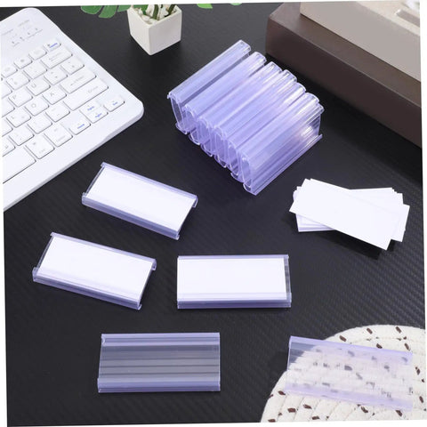Heavy Duty PVC Wire Shelf Label Holders 30 Pack Clear Display Fronts on a desk with price tag cards and keyboard.