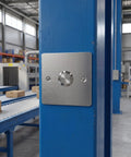 Stainless Steel Emergency Stop Push Button Panel Mount Switch Built Like A Tank For Heavy Duty Industrial Machine Control With Instant Safe Shutdown No Nonsense Workhorse Gear mounted on blue pillar in warehouse.