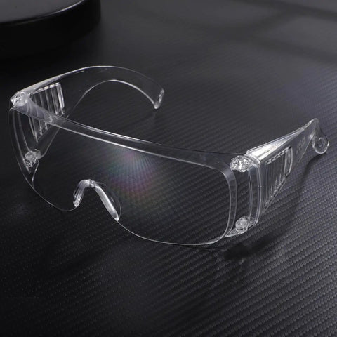 Real Deal 6 Pack Clear Lab Safety Glasses Featuring Ventilated Side Shields And Lightweight Wraparound Design For Shop Splashes And Daily Eye Protection Making Work A Breeze, clear glasses on dark textured background.