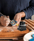 Woodworker using Mini Bench Clamp With Suction Base Table Vise Flat Jaw Workholding Fixture For Woodworking Crafting And Micro Carving.