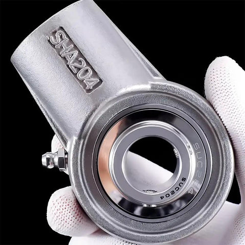 Pro Grade Stainless Steel Outer Spherical Insert Bearing With M16 Thread And Rust Proof Shell For Easy Shop Installations and Reliable Daily Grind Performance held in a gloved hand.
