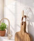 Water Ripple Hexagonal Adhesive Wall Hooks, Super Grippy No Drill Bathroom and Kitchen Organization System for hanging a wooden cutting board.