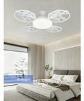 Modern MENGLANSI Flush Mount Fan Light with four fans, white finish, illuminating a stylish bedroom interior.