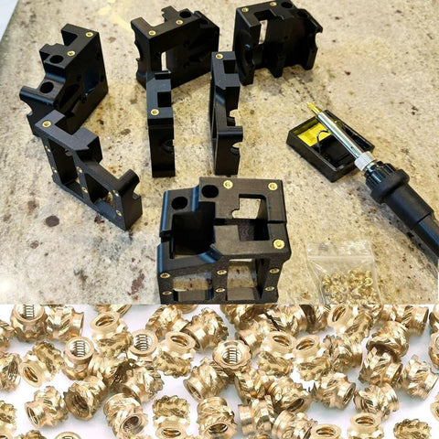 Front view of heat-set insert tools kit with black modular blocks and brass inserts, plus a 60W soldering iron.