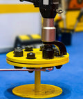 Internal Tooth Lock Washer Assortment Kit being used with bolts on a yellow circular fixture for mechanical assembly.