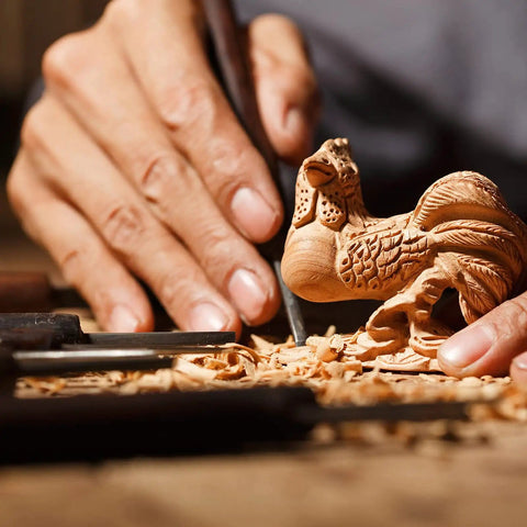 Person carving a detailed rooster figurine from block in 12 Pack Unfinished Basswood Carving Blocks Kit Rectangular Wooden Blocks For Diy Carving Crafts And Whittling 4 By 1 By 1 Inch Blocks For Adults Beginners And Experts Smooth Burr Free Non Toxic Natural Wood