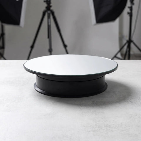 Slick Spinning Eight Inch Motorized Display Turntable Stand With Adjustable Speed And Polished Mirror Base on a flat surface.