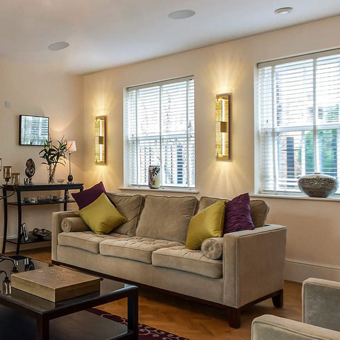 Living room with Hot Gold 19 Inch LED Wall Sconce With Crystal Bubble Glass, dimmable warm 3000K light next to windows
