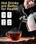 Person pouring hot water from Stovetop Whistling Tea Kettle, 2 Quart Stainless Steel Pot into glass cup of tea on table