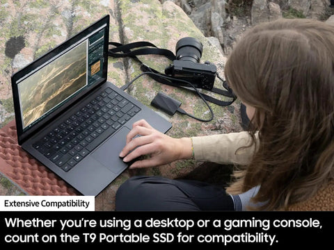 Person using laptop with T9 Portable SSD 2TB External Solid State Drive With USB 3 2 Gen 2x2 And Read Speeds Up To 2000MB Per Second nearby