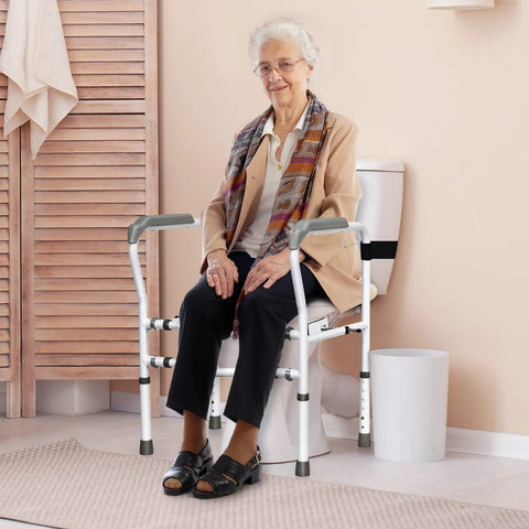 Rock Solid Free Standing Toilet Safety Rail With Quick Adjust Height And Width Settings Secure Bathroom Handrail For Aging Adults 300 Pound Load Capacity Hassle Free Setup with elderly woman seated.