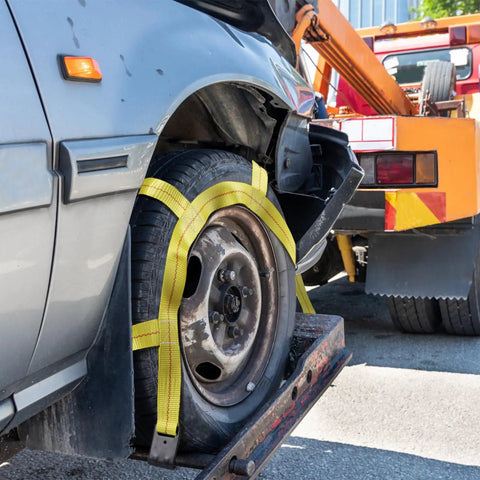 Heavy Duty Tow Dolly Basket Straps Two Pack With Flat Steel Hooks For 15 To 19 Inch Car Tires on a tire, securing it for transport.