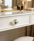 Hella Cute Yellow Honey Bee Ceramic Drawer Knobs And Cabinet Pulls, 6 Pack Set with Screws on a white dresser drawer.