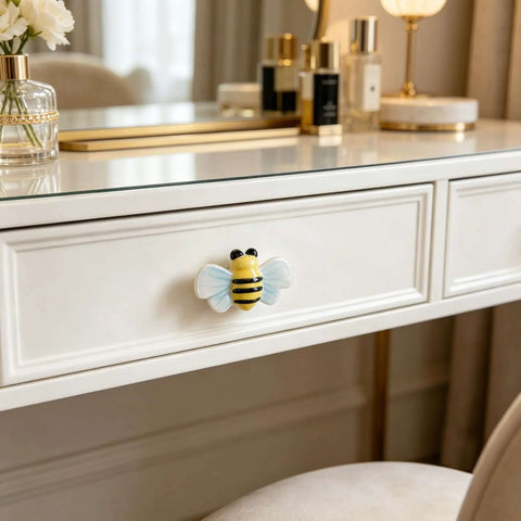 Hella Cute Yellow Honey Bee Ceramic Drawer Knobs And Cabinet Pulls, 6 Pack Set with Screws on a white dresser drawer.