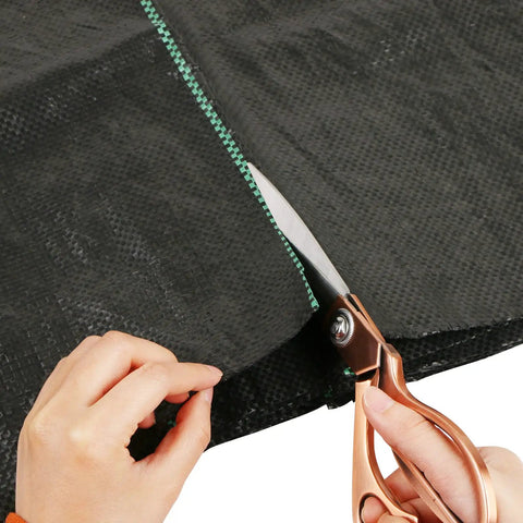 Heavy Duty Weed Barrier Landscape Fabric 3ft x 10ft Ground Cover being cut along green guide line for outdoor gardens
