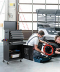Boss Level Shop Storage Roll This Five Drawer Tool Chest Straight To Your Garage With A Snazzy Detachable Top Box And Heavy Duty Black Finish For Seamless Rolling, shown with tools and repair work.