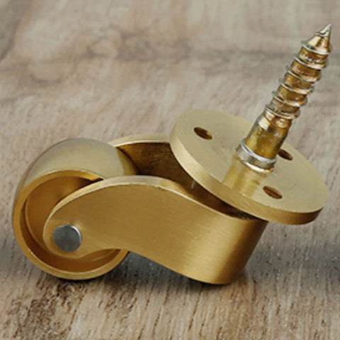 Premium Polished Brass Swivel Casters With 22 mm Wheels And 360 Degree Rotation on wood surface, showcasing sturdy design for furniture.