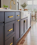Six Pack Antique Brass Cabinet Cup Pulls Three Inch Center To Center Spacing on kitchen drawers with dark finish.