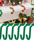 Heavy Duty Christmas Adhesive Wall Hooks For Stockings And Garland Damage Free Clear Sticky Holders With Chill Out Setup For Sweet Grip Mantel Holiday Decoration on a mantel with green silicone hooks.
