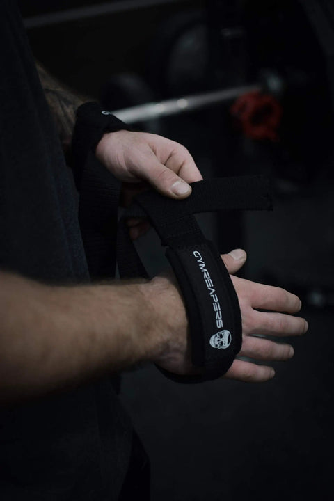 Sick Grip Black Cotton Lifting Wrist Straps Featuring Hella Padded Neoprene Cuffs for Heavy Deadlifts and Powerlifting Beast Mode Workouts Demanding Serious Wrist Support and Flawless Form During Tough Training Days, being secured on wrists.