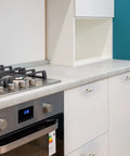 Modern kitchen with white cabinets featuring 10 Pack Cabinet Knobs In Brushed Nickel And Gold Finishes, single hole design installed.