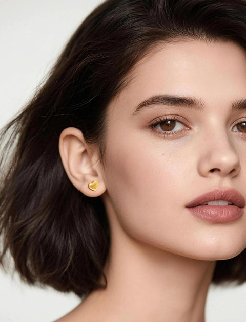 Close-up of a model wearing Implant Grade F136 Titanium Cubic Zirconia Stud Earrings Secure Screw Back, heart-shaped design.