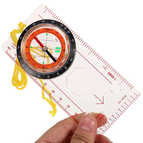 Trail Ready Multifunction Hiking Compass With Map Ruler, Portable Lightweight Navigation Tool held in hand, showing map ruler