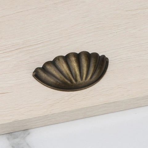 Four Pack Bronze Semicircle Cabinet Pulls Featuring Heavy Duty Zinc Alloy Build And Hella Tough Grip For Kitchen Drawers on wooden surface.
