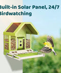 Smart Bird Feeder With Camera For Outdoors All Metal Durability Solar Powered Auto Identify And Record Video Instant Alerts Live Bird Watching, featuring a built-in camera and solar panel, mounted on a wall with a finch in flight nearby.