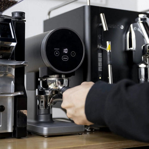 Straight Fire Electric Coffee Tamper 58mm with digital screen, adjusting pressure while brewing espresso at home.