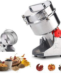 High Speed Stainless Steel Grain Grinder Machine For Milling Grains Beans Spices Herbs And Dried Medicinal Herbs Into Fine Powder Swing Type Mill With Easy Cleaning And Heavy Duty Performance. Stainless steel chamber with red knob, spices pictured below.