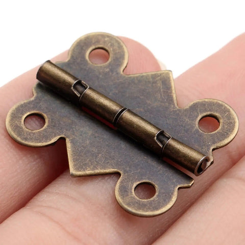 Close-up of 20 Piece Butt Hinge Set With Screws In Antique Bronze Finish For Wooden Jewelry Boxes Cabinets Doors And Wine Cases 25 By 20 mm Solid Built