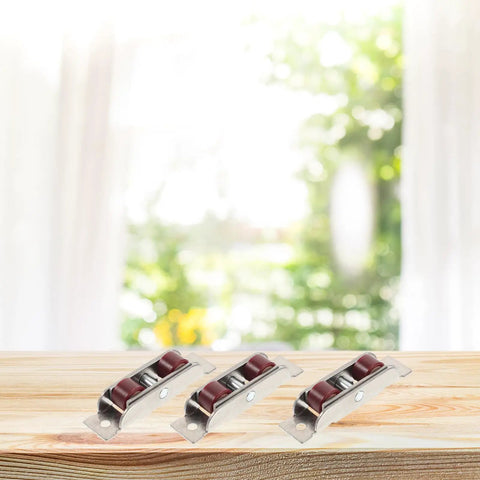 Four Piece Stainless Steel Double Roller Sash Pulley Wheels Pro Grade Hardware For Sliding Windows And Doors Smooth As Butter Replacement Parts Quick Swap Design on wooden table with blurred background.