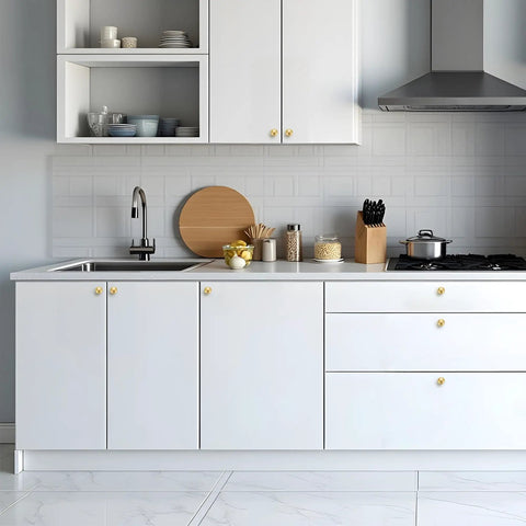 Rock Solid Zinc Alloy Cabinet Pulls Featuring A Slick Brushed Gold Finish 1 1/4 Inch Diameter Heavy Duty kitchen hardware on modern white kitchen cabinets.