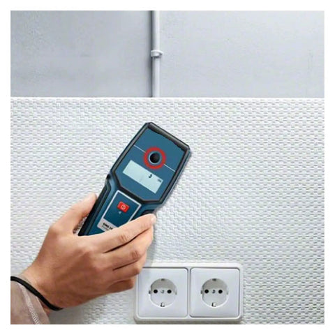 Stud Finder Wall Scanner with AC DC Voltage Test being held against textured wall near electrical outlets.